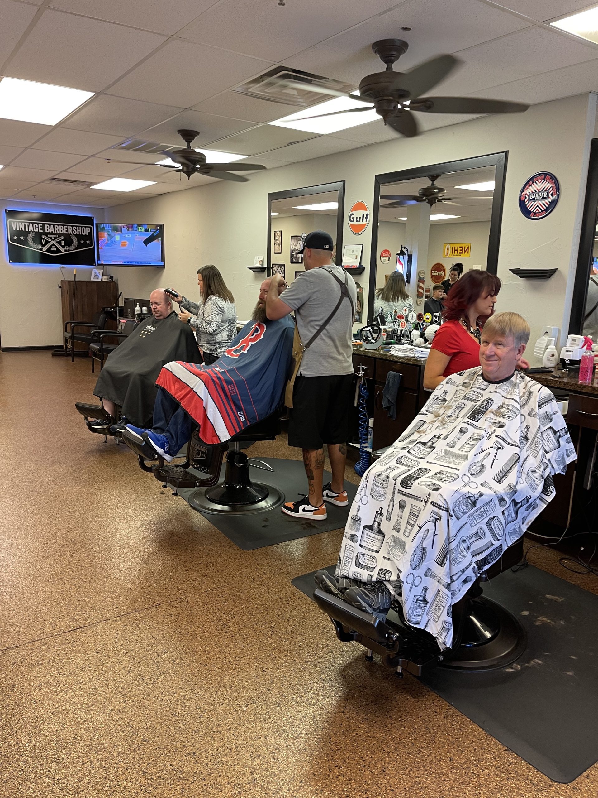 three barbers attending to clients