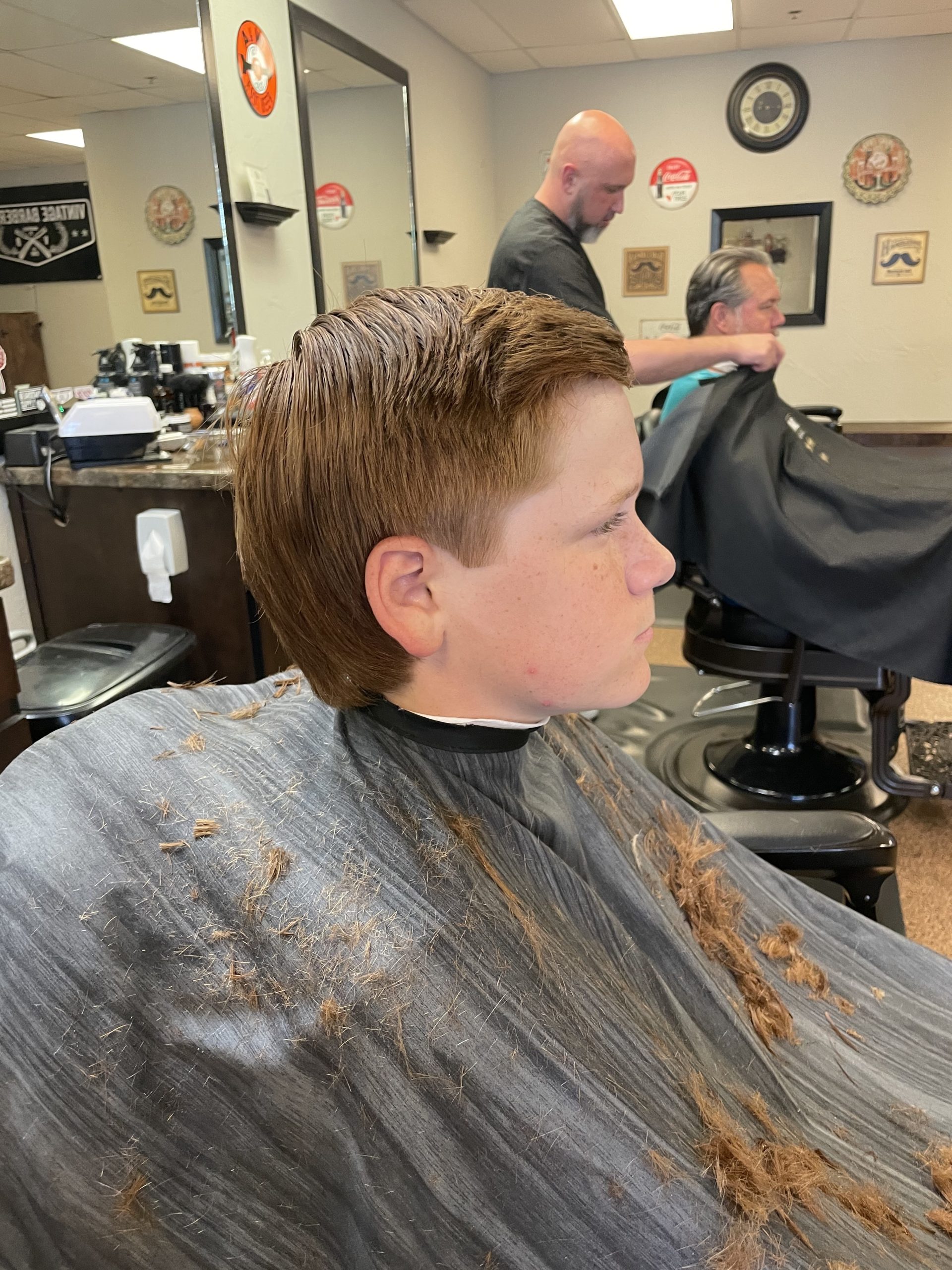 young boy with new hair cut