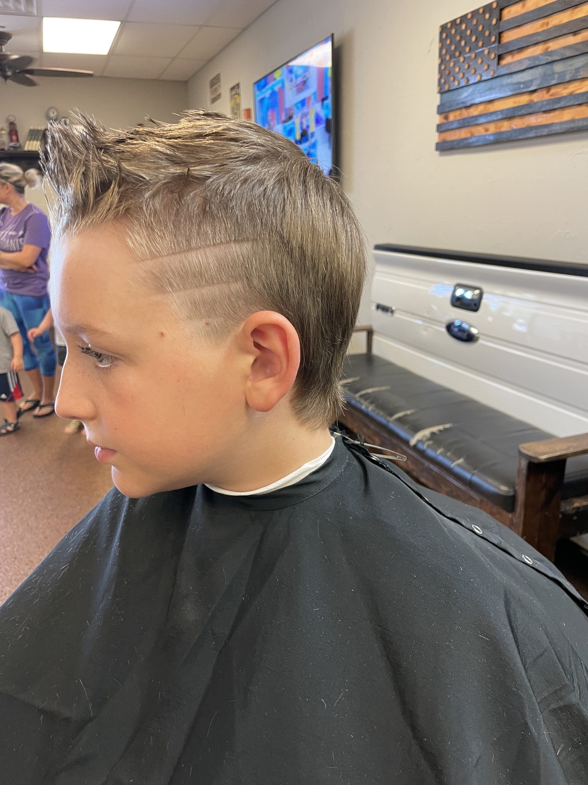 young boy's fade hair cut with design